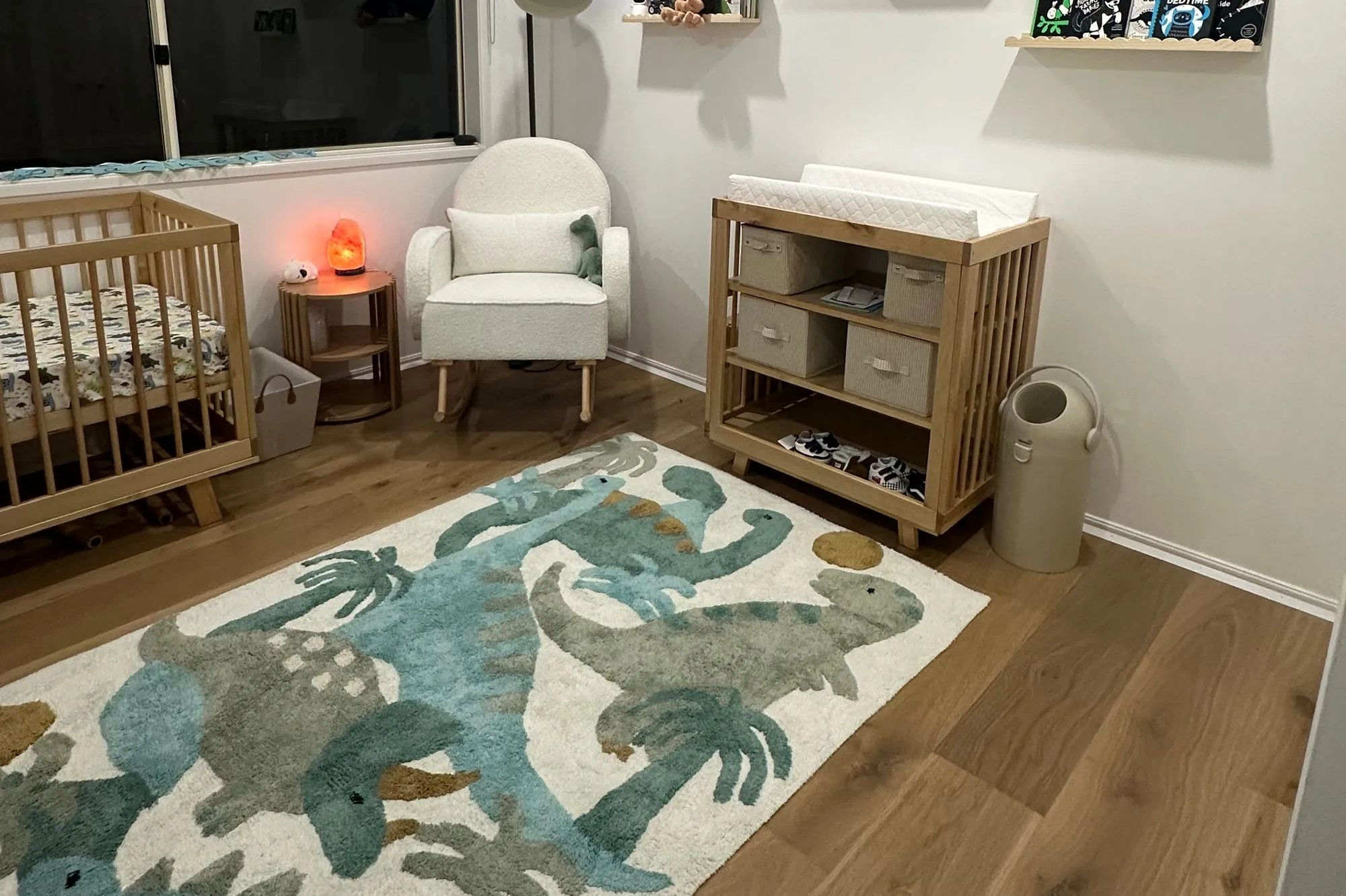 Parker’s room, ready for him: the cot, the chair, and a dinosaur rug on the floor.
